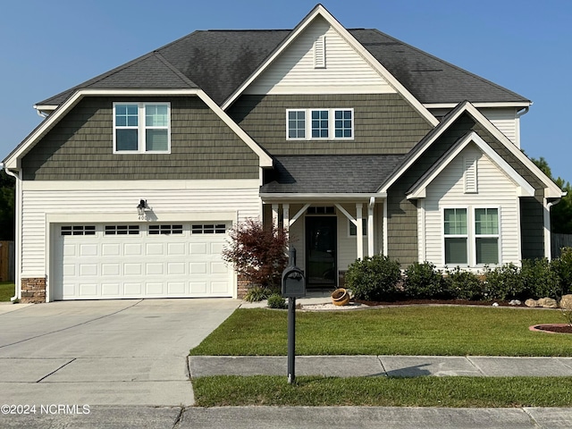 craftsman-style home featuring a front yard and a garage