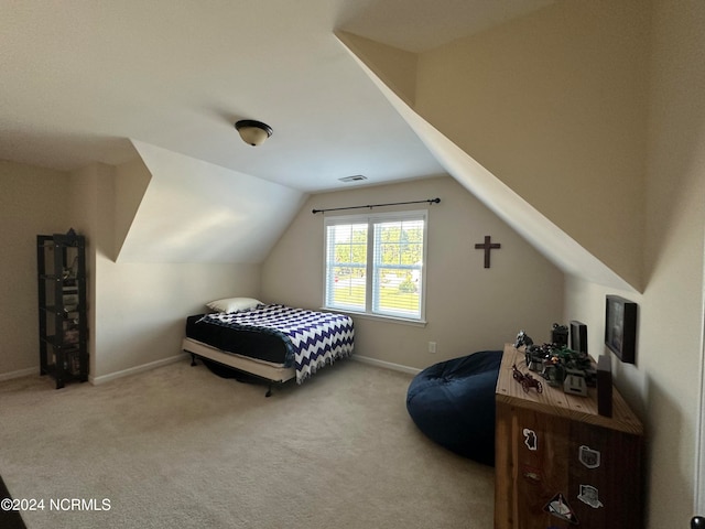 bedroom featuring light carpet and lofted ceiling