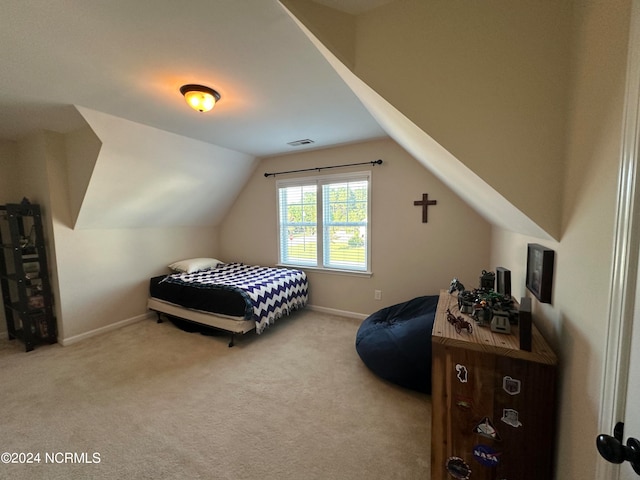 carpeted bedroom with vaulted ceiling