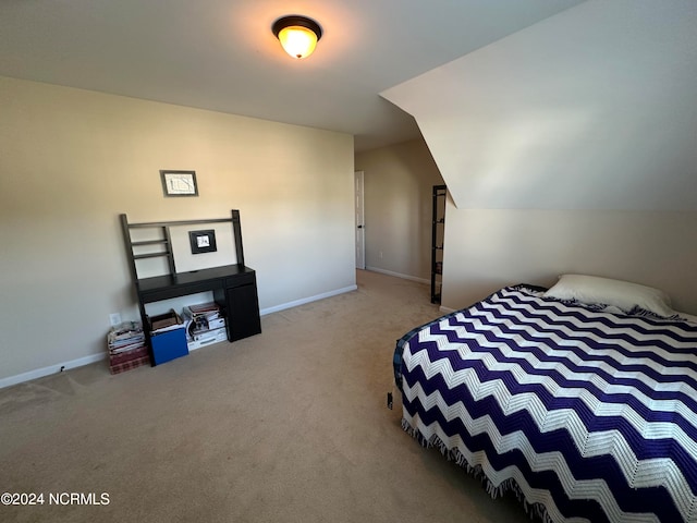 carpeted bedroom with vaulted ceiling