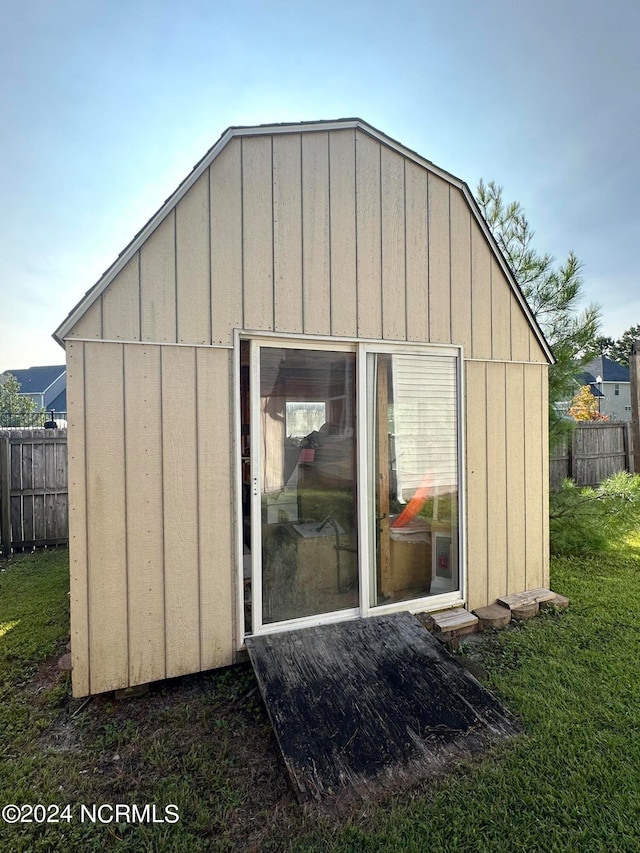 view of outdoor structure featuring a lawn