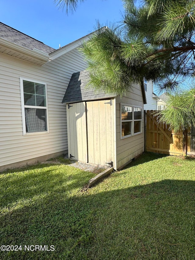 view of outbuilding with a lawn