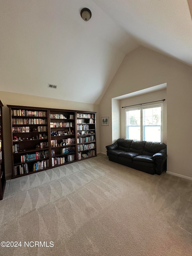 unfurnished room with carpet and lofted ceiling