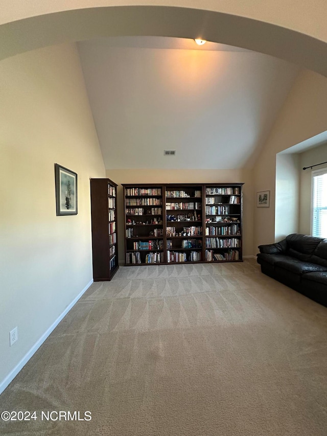 unfurnished room featuring light carpet and high vaulted ceiling