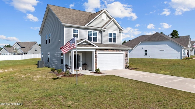 view of front facade featuring a front lawn, a garage, and central air condition unit