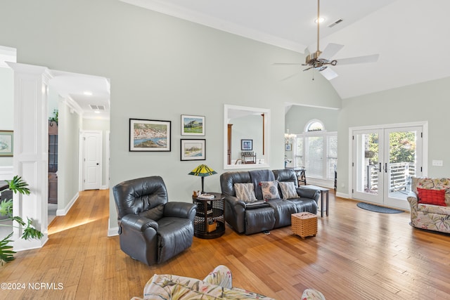 living room with french doors, crown molding, high vaulted ceiling, ceiling fan, and light wood-type flooring