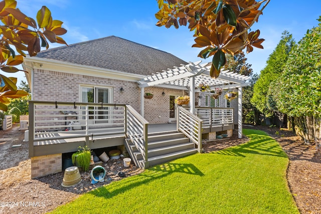 rear view of property with a pergola, a yard, and a wooden deck
