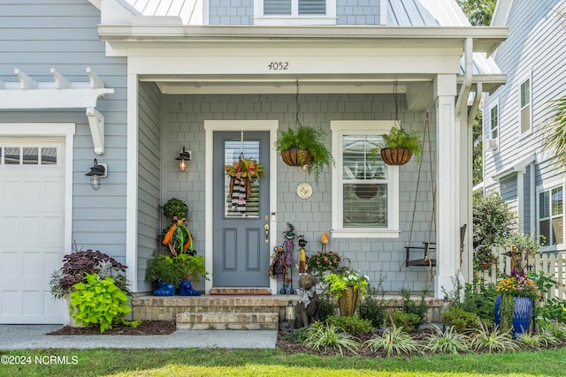 property entrance with a garage and a porch