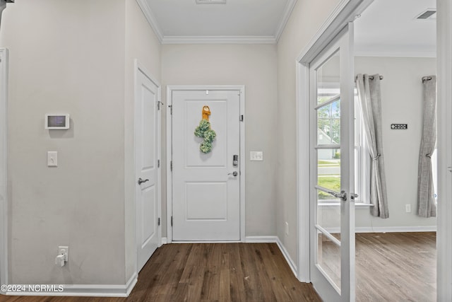 foyer featuring dark wood-type flooring, a wealth of natural light, and ornamental molding