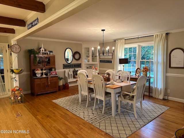 dining area featuring crown molding, beamed ceiling, light hardwood / wood-style flooring, and a notable chandelier