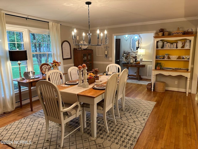 dining room featuring an inviting chandelier, crown molding, hardwood / wood-style floors, and a baseboard radiator