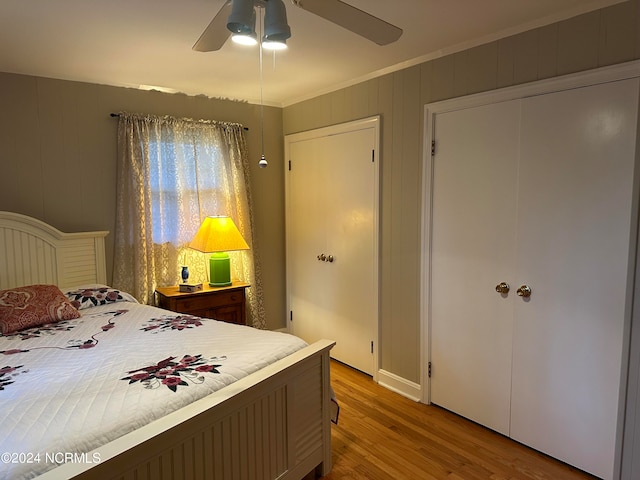 bedroom featuring ceiling fan, hardwood / wood-style flooring, a closet, and ornamental molding