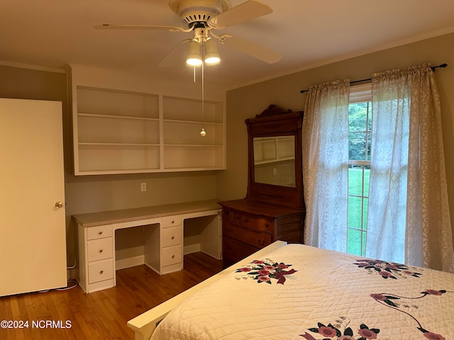 unfurnished bedroom featuring ceiling fan, ornamental molding, and dark wood-type flooring