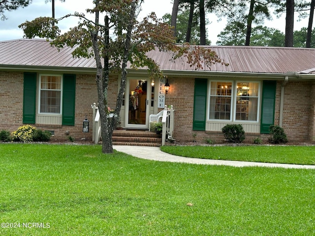 ranch-style house with a front lawn