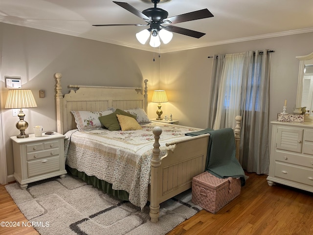 bedroom with ornamental molding, light hardwood / wood-style floors, and ceiling fan