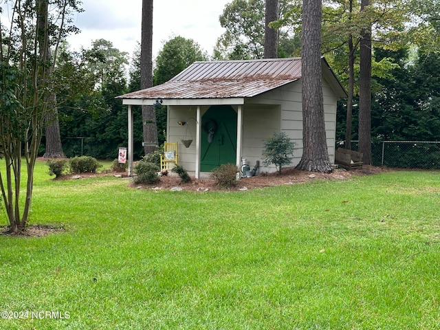 view of outbuilding with a yard