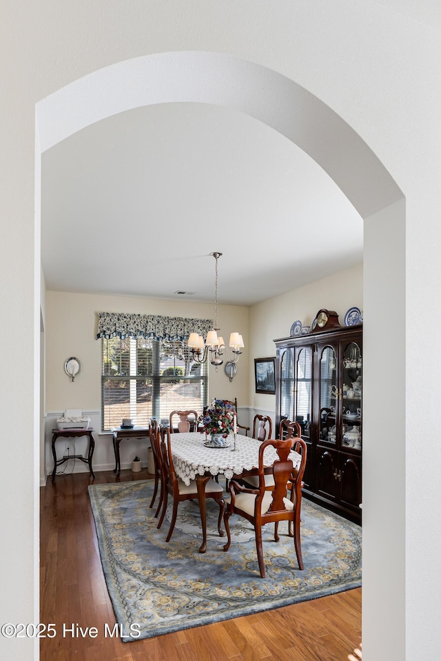 dining room with an inviting chandelier and wood finished floors