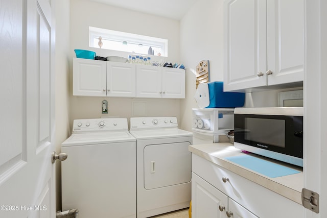 laundry area featuring washing machine and dryer and cabinet space