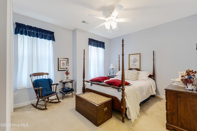 bedroom featuring a ceiling fan, visible vents, light carpet, and baseboards