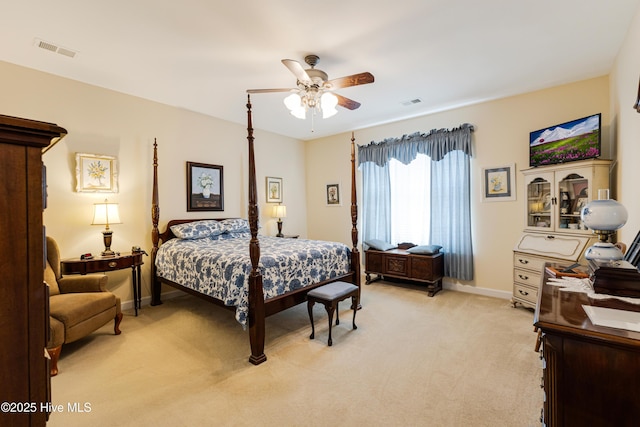 bedroom with baseboards, ceiling fan, visible vents, and light colored carpet