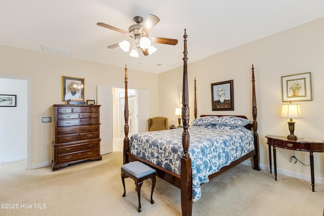 bedroom featuring light carpet, visible vents, baseboards, and a ceiling fan