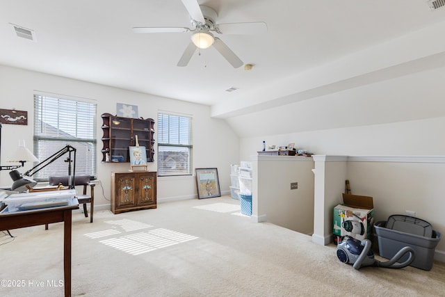 interior space featuring baseboards, visible vents, vaulted ceiling, and light colored carpet