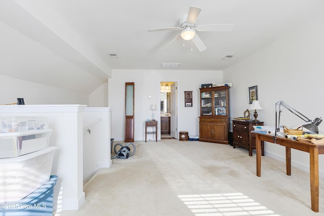 interior space featuring light carpet, ceiling fan, visible vents, and vaulted ceiling