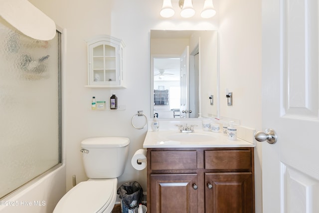 full bathroom with bath / shower combo with glass door, toilet, and vanity