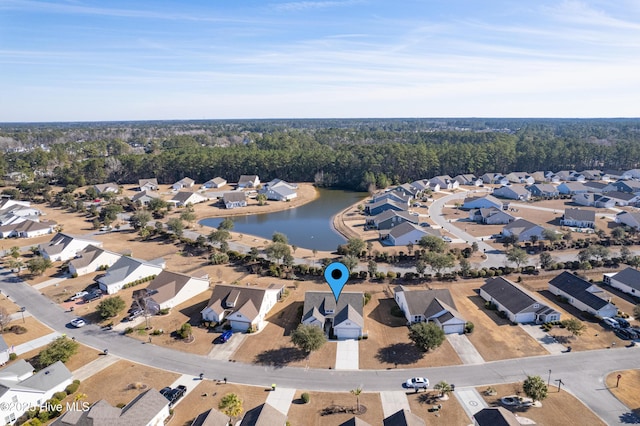 drone / aerial view featuring a water view and a residential view