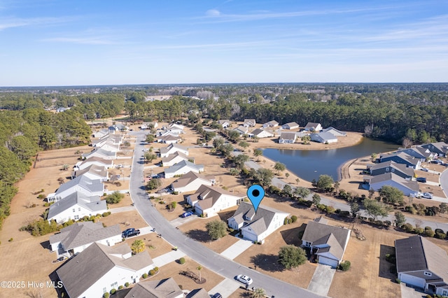 bird's eye view with a forest view, a water view, and a residential view