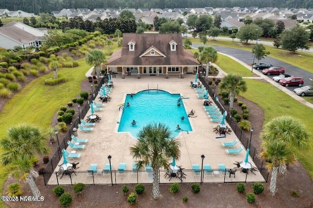 pool featuring fence and a patio