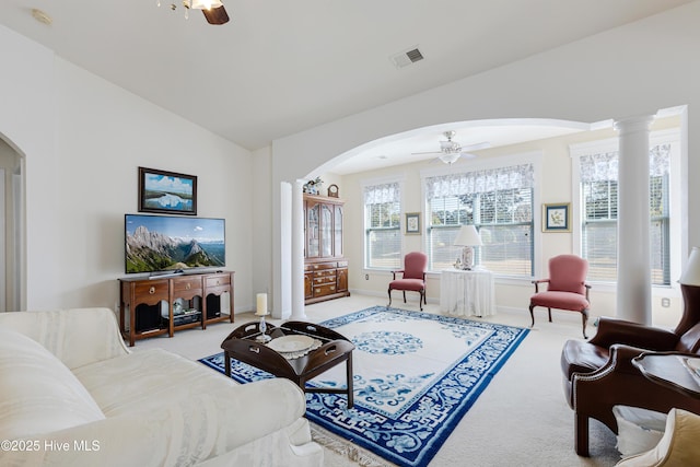 living room with ceiling fan, light colored carpet, and ornate columns