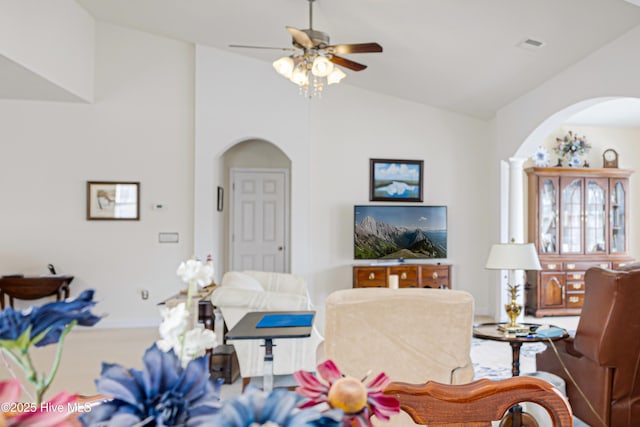 living area featuring visible vents, vaulted ceiling, and ceiling fan