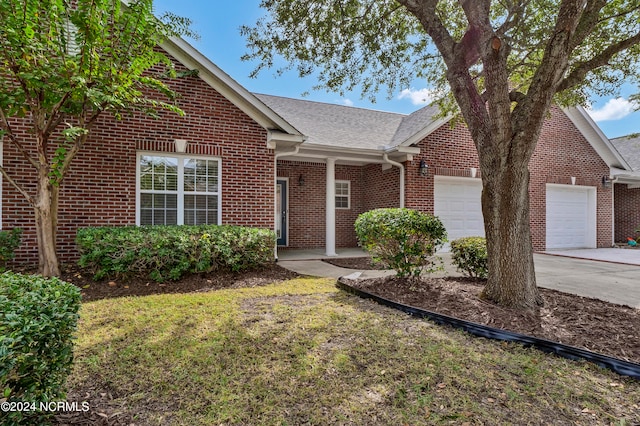 view of front of home with a front yard and a garage