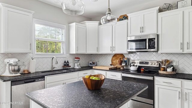 kitchen featuring stainless steel appliances, sink, and white cabinetry