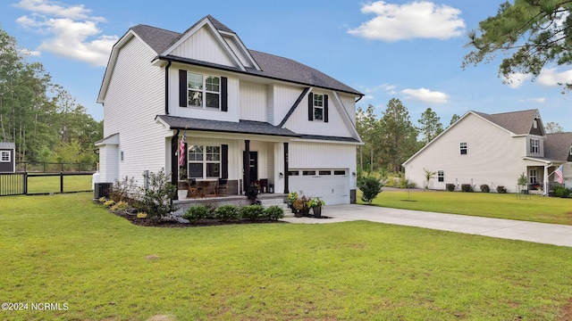 view of front facade featuring a garage, a porch, a front lawn, and central air condition unit