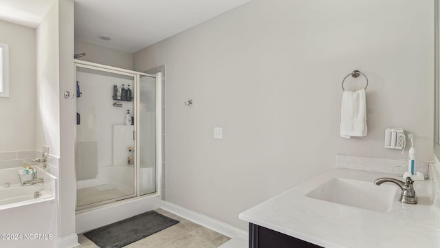 bathroom with shower with separate bathtub, tile patterned flooring, and vanity