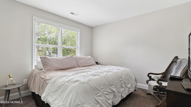 bedroom featuring dark carpet