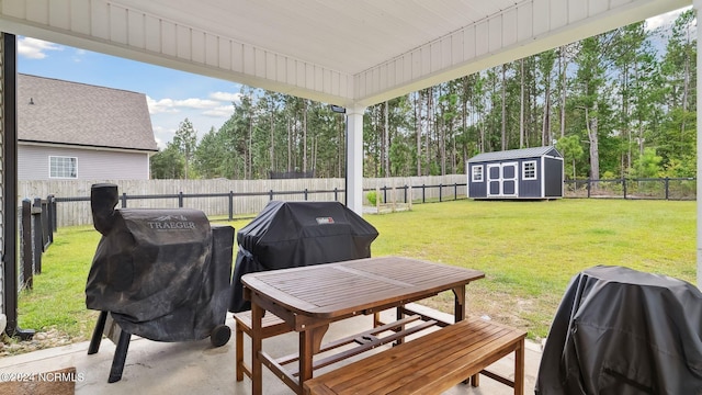 view of patio with area for grilling and a storage shed