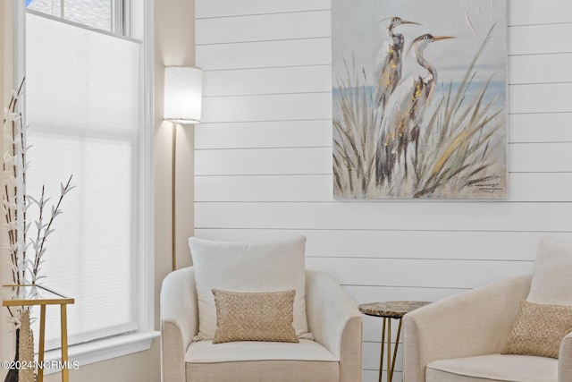 sitting room featuring wood walls