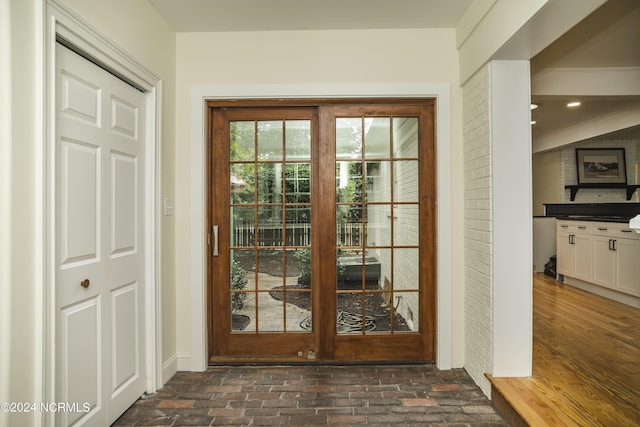 doorway to outside with brick floor