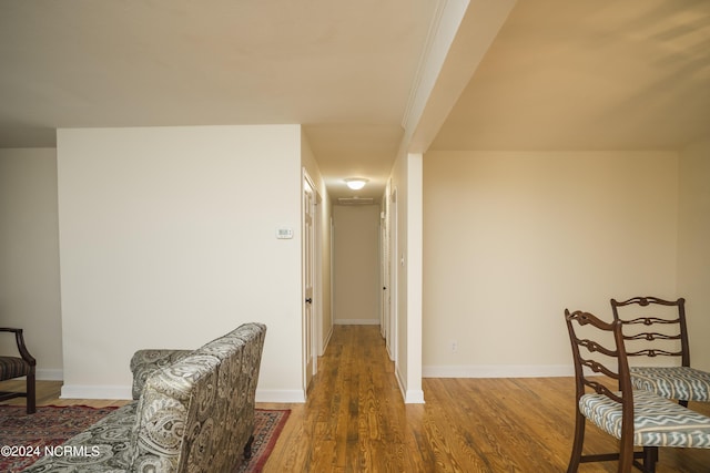 hallway with baseboards and wood finished floors