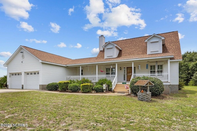 view of front of house with a garage, a front yard, and a porch