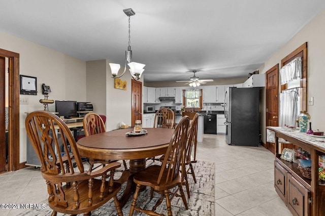 dining room with ceiling fan with notable chandelier and light tile patterned flooring