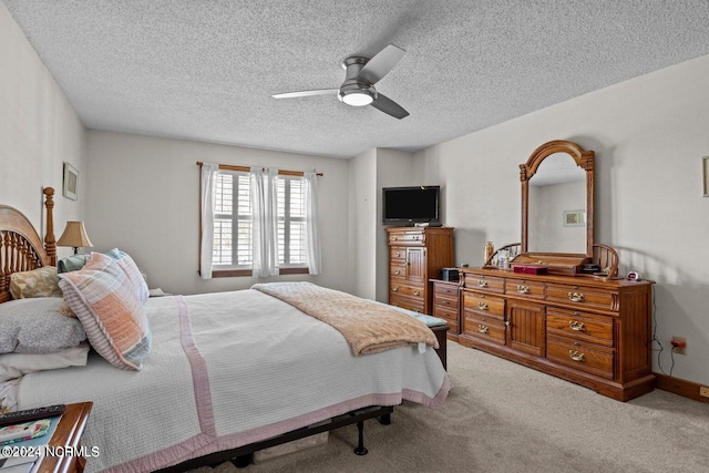 carpeted bedroom with a textured ceiling and ceiling fan