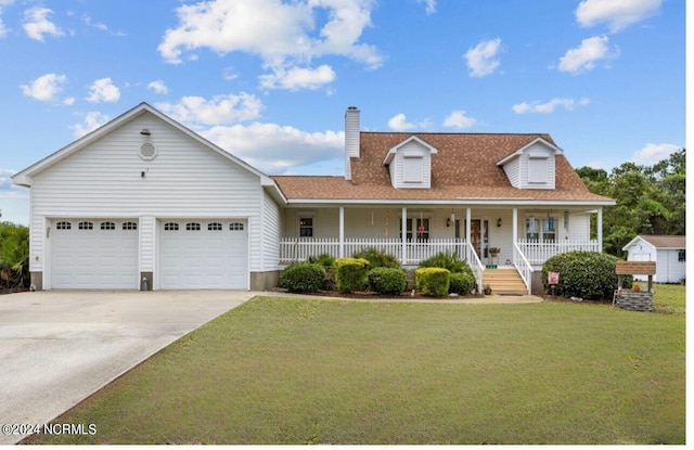 view of front of home featuring a front lawn, a garage, and a porch