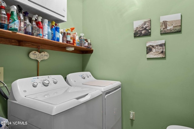 laundry room with cabinets and washing machine and dryer