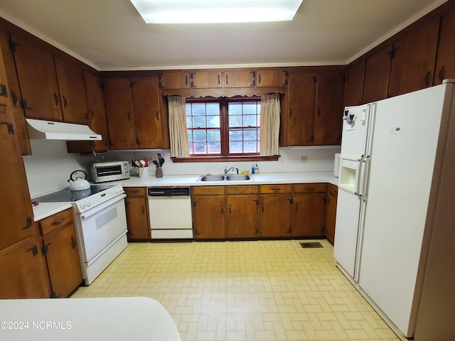 kitchen featuring white appliances and sink