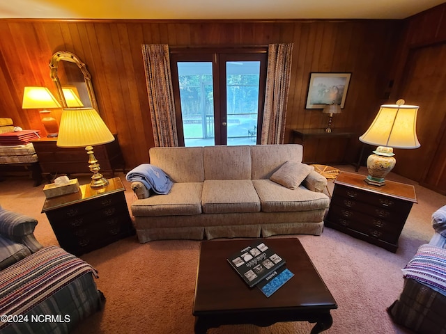 living room with carpet and wood walls