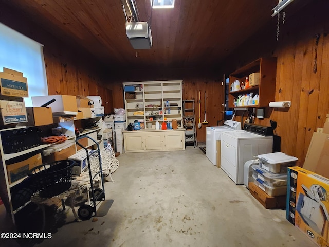 garage featuring washer and dryer, wood ceiling, and wooden walls